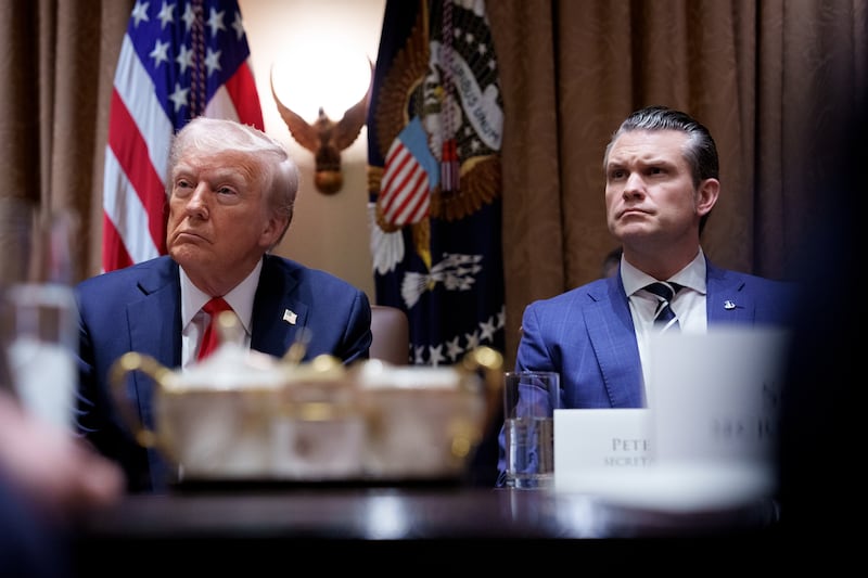 Donald Trump and Pete Hegseth appear during a Cabinet meeting at the White House on Feb. 25.