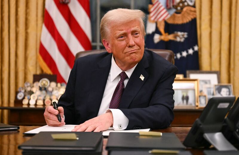 US President Donald Trump signs executive orders in the Oval Office of the White House in Washington, DC, on January 20, 2025.