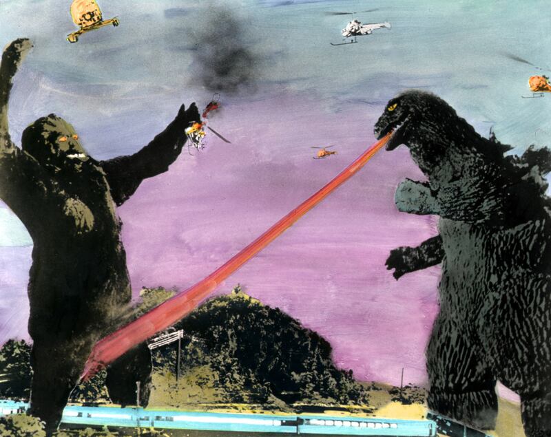 Godzilla breathes flames at King Kong in a still from an animated movie