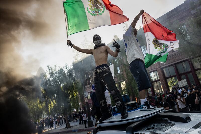 Demonstrators protest immigration raids.