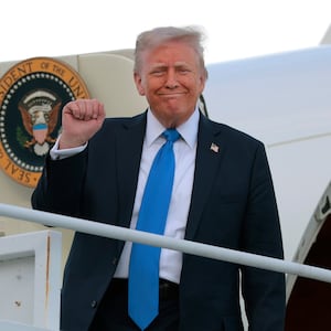 U.S. President Donald Trump disembarks from Air Force One.