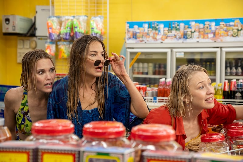 Three women in a grocery store.