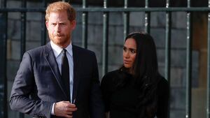 Prince Harry and Meghan Markle walk outside Windsor Castle.