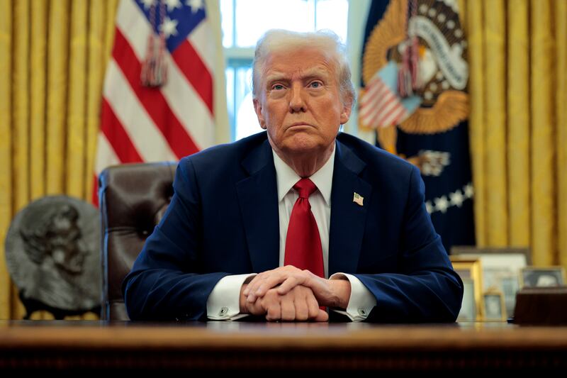U.S. President Donald Trump talks to reporters from the Resolute Desk after signing an executive order to appoint the deputy administrator of the Federal Aviation Administration in the Oval Office at the White House on January 30, 2025 in Washington, DC.