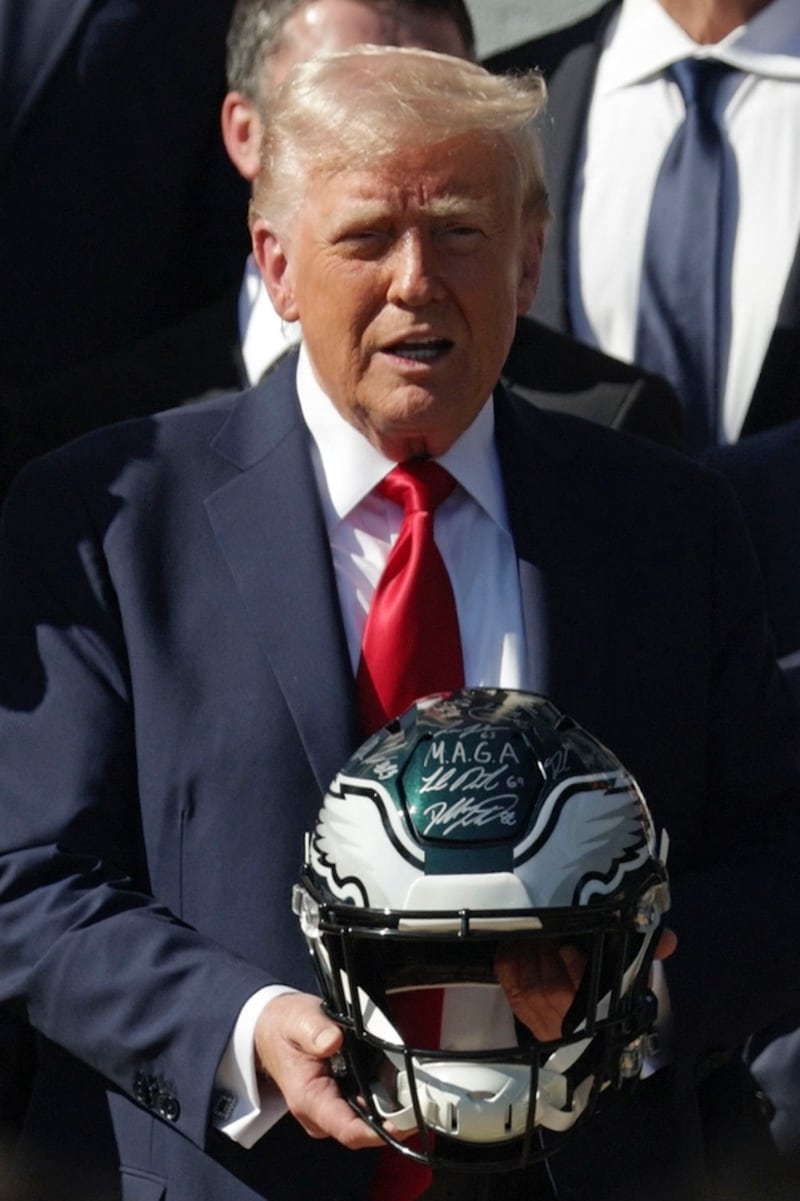 U.S. President Donald Trump holds an NFL Philadelphia Eagles helmet during an event on the South Lawn of the White House on April 28, 2025 in Washington, DC.