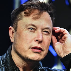 ANKARA, TURKIYE - NOVEMBER 7: In this photo illustration, Elon Musk's photo is displayed in front of Grok logo on a phone screen, in Ankara, Turkiye on November 7, 2023. (Photo by Muhammed Selim Korkutata/Anadolu via Getty Images)