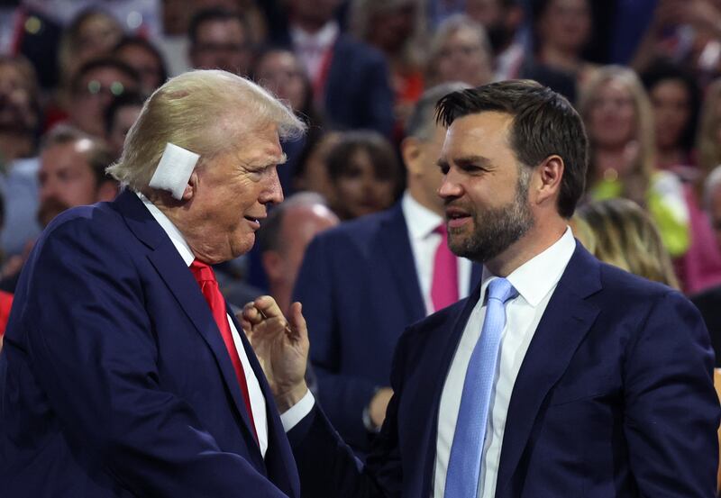 Republican presidential nominee and former U.S. President Donald Trump and Republican vice presidential nominee J.D. Vance interact during Day 1 of the Republican National Convention.