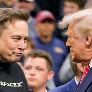 Tesla CEO Elon Musk greets U.S. President Donald Trump as they attend the NCAA men's wrestling championships in Philadelphia, Pennsylvania, U.S., March 22, 2025. REUTERS/Nathan Howard