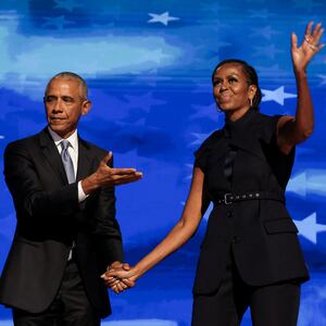 Former U.S. first lady Michelle Obama greets her husband, former U.S. President Barack Obama, on stage during Day 2 of the Democratic National Convention (DNC) in Chicago, Illinois, U.S., August 20, 2024.