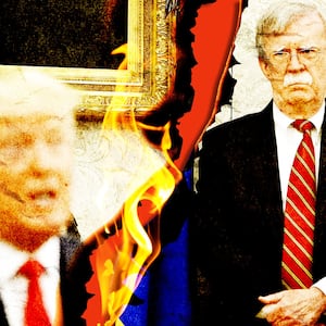Donald Trump and John Bolton on a piece of split paper on fire