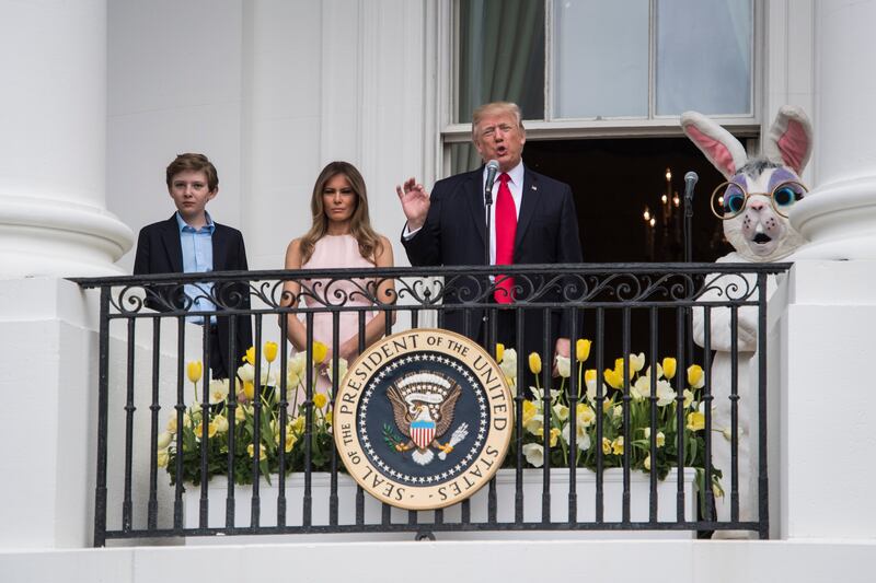 President Donald Trump, First Lady Melania Trump, and their son Barron Trump speak from the Truman Balcony during the 139th Easter Egg Roll in 2017.