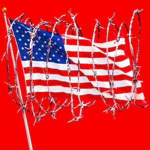 A photo illustration of the American flag wrapped in barbed wire.