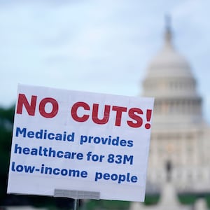 Sign reading "no cuts! Medicaid provides healthcare for 83M low-income people" at a protest near the Capitol in Washington, DC.