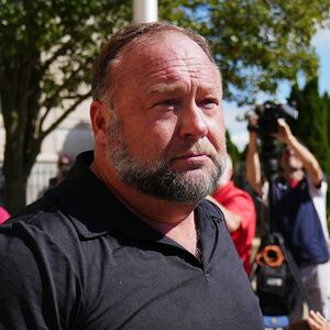 InfoWars founder Alex Jones walks outside Waterbury Superior Court during his trial in 2022. 