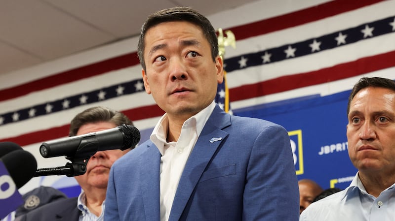 Texas State Rep. Gene Wu speaks near Illinois Governor J.B. Pritzker after state Democratic lawmakers left Texas to deny Republicans the quorum needed to redraw the state's congressional districts.