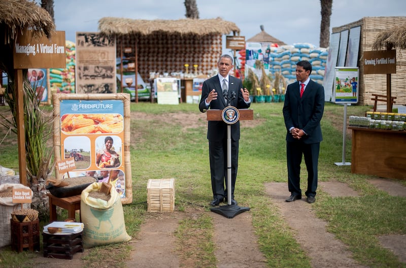 US President Barack Obama speaks June 28, 2013 before USAID administrator Raj Shah (R) during an event on food security in Dakar. Obama flies to South Africa later on June 27 to pay homage to his former President Nelson Mandela, who is fighting for his life in hospital.      AFP PHOTO/JIM  WATSON        (Photo credit should read JIM WATSON/AFP via Getty Images)