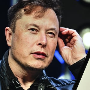 ANKARA, TURKIYE - NOVEMBER 7: In this photo illustration, Elon Musk's photo is displayed in front of Grok logo on a phone screen, in Ankara, Turkiye on November 7, 2023. (Photo by Muhammed Selim Korkutata/Anadolu via Getty Images)