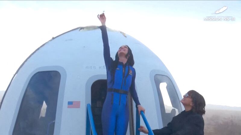 Pop star Katy Perry comes out of the capsule after the short flight.