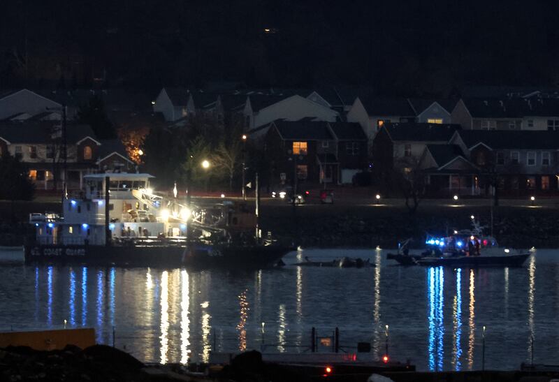 A Coast Guard crane arrives to remove the wreckage of a military Black Hawk helicopter after the crash of an American Airlines plane on the Potomac River as it approached the airport on January 31, 2025 in Arlington, Virginia. The American Airlines flight from Wichita, Kansas collided midair with a military Black Hawk helicopter while on approach to Ronald Reagan Washington National Airport. According to reports, there were no survivors among the 67 people on both aircraft.