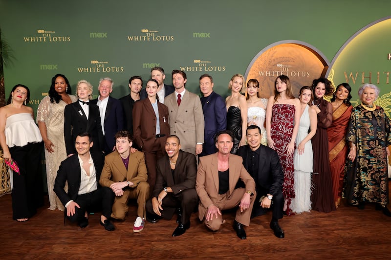 LOS ANGELES, CALIFORNIA - FEBRUARY 10: (L-R) Morgana O'Reilly, Natasha Rothwell, Julian Kostov, Carrie Coon, Mike White, Sam Nivola, Arnas Fedaravičius, Charlotte Le Bon, David Bernad, Nicholas Duvernay, Patrick Schwarzenegger, Jason Isaacs, Walton Goggins, Leslie Bibb, Tayme Thapthimthong, Lisa, Aimee Lou Wood, Sarah Catherine Hook, Parker Posey, Shalini Peiris and Lek Patravadi attend the Los Angeles Premiere of HBO Original Series "The White Lotus" Season 3 at Paramount Theatre on February 10, 2025 in Los Angeles, California.