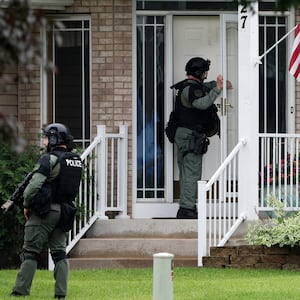 Officers canvas the neighborhood after what police said was a targeted shooting in the area around Edinburgh Golf Course in the Minneapolis suburb of Brooklyn Park, Minnesota, U.S. June 14, 2025.