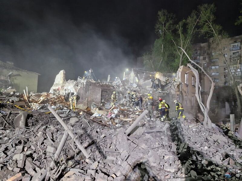KYIV, UKRAINE - APRIL 24: Rescue workers search for people under rubble of an apartment building in Svyatoshynskyi district destroyed by a Russian missile strike on April 24, 2025 in Kyiv, Ukraine. In the early morning, Russia has launched a mass combined attack on the Ukrainian capital, and other cities of Ukraine. The strike on Kyiv resulted in the destruction of multi-story residential buildings, damage to administrative buildings, and non-residential buildings. At least ten people were killed and 63 were injured, including six children. Rescue workers continue to search for people under the rubble. (Photo by Roman Petushkov/Global Images Ukraine via Getty Images)