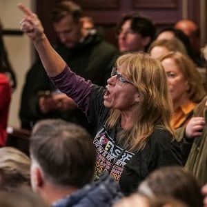 An attendee yells out in response to an answer by Republican U.S. Rep. Rich McCormick during a town hall meeting on Thursday, February 20, 2025 in Roswell, GA.