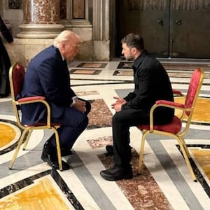 Trump and Zelensky hunched over in discussion at the funeral of Pope Francis