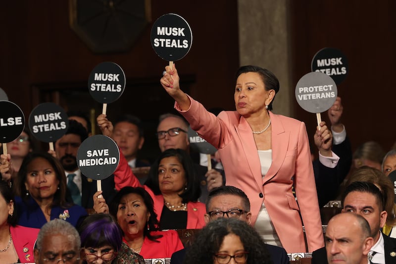 Rep. Nydia Velázquez (D-NY) and fellow Democrats wave as  President Donald Trump address a joint session of Congress at the U.S. Capitol on March 4, 2025 in Washington, D.C.