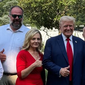 Donald Trump smiles with the loved ones of a fallen marine.