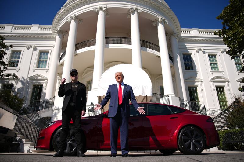 Elon Musk and Donald Trump in front of White House with Tesla.