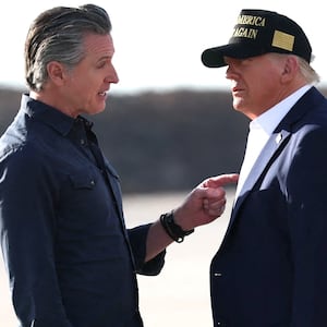 Governor of California Gavin Newsom talks to U.S. President Donald Trump upon Trump's arrival to tour areas impacted or destroyed by the southern California wildfires, at Los Angeles International Airport in Los Angeles, California, U.S., January 24, 2025.