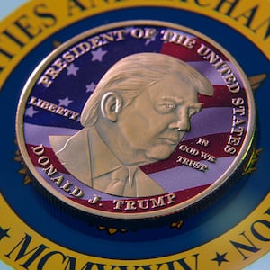 This photo illustration shows a representation of cryptocracy coins with the $Trump meme coin (collection coin) in Brussels, Belgium, on March 3, 2025. (Photo by Jonathan Raa/NurPhoto via Getty Images)