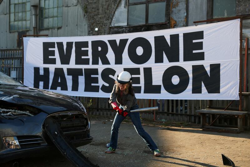 FILE PHOTO: A person smashes a Tesla car, donated anonymously and destined for scrap during a stunt organised by the group Everyone Hates Elon, part of a campaign against Tesla CEO Elon Musk’s political involvement in the U.S. government, in London, Britain, April 10, 2025. REUTERS/Hannah McKay/File Photo
