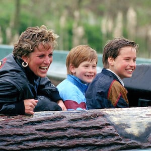 Princess Diana with her sons at an amusement park. The boys are locked into a battle over her legacy.