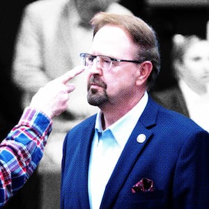 Veteran, Sam Bingham points at Rep. Chuck Edwards (R-NC) before a congressional town hall meeting on March 13, 2025 in Asheville, North Carolina.