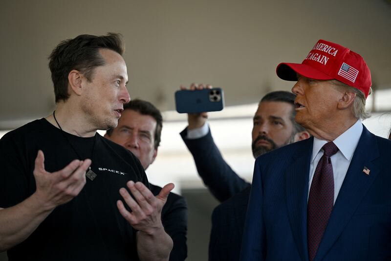 Elon Musk speaks with U.S. President-elect Donald Trump at a viewing of the launch of the sixth test flight of the SpaceX Starship rocket, in Brownsville, Texas, U.S., November 19, 2024 .