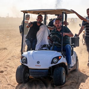 An Israeli hostage is taken to Gaza City.