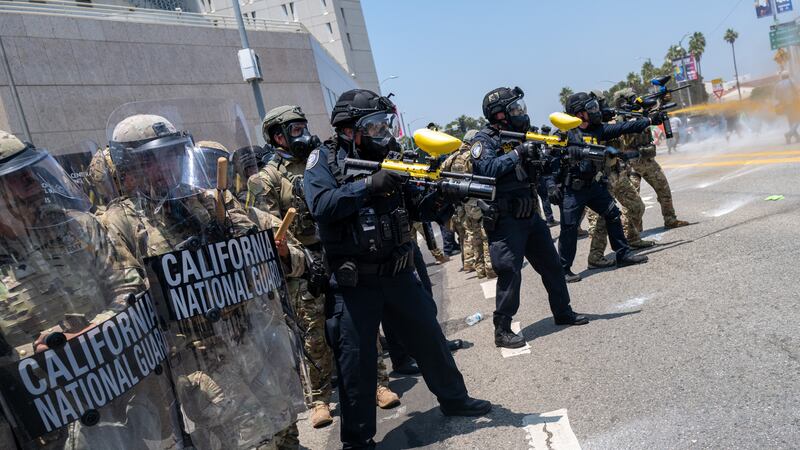 The National Guard, police and protesters stand off outside of a downtown jail in Los Angeles on Sunday.