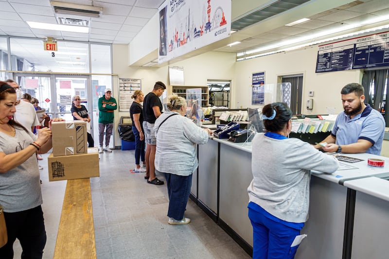 Miami Beach, Florida, US post office counter, busy with customers. (Photo by: Jeffrey Greenberg/Universal Images Group via Getty Images)