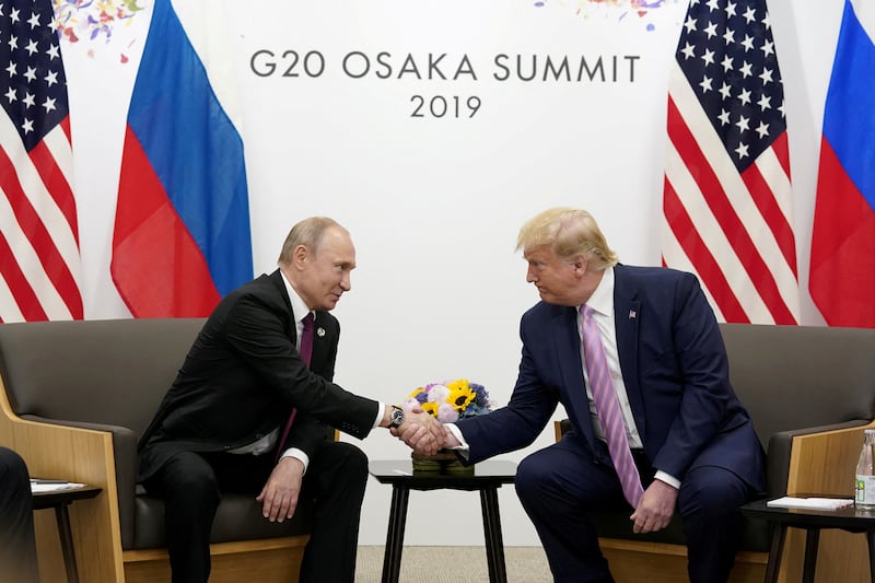 Russia's President Vladimir Putin and U.S. President Donald Trump shake hands during a bilateral meeting at the G20 leaders summit in Osaka, Japan,