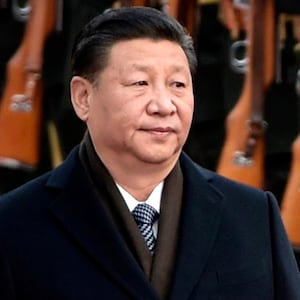China's President Xi Jinping (L) and US President Donald Trump review Chinese honor guards during a welcome ceremony at the Great Hall of the People in Beijing on November 9, 2017.