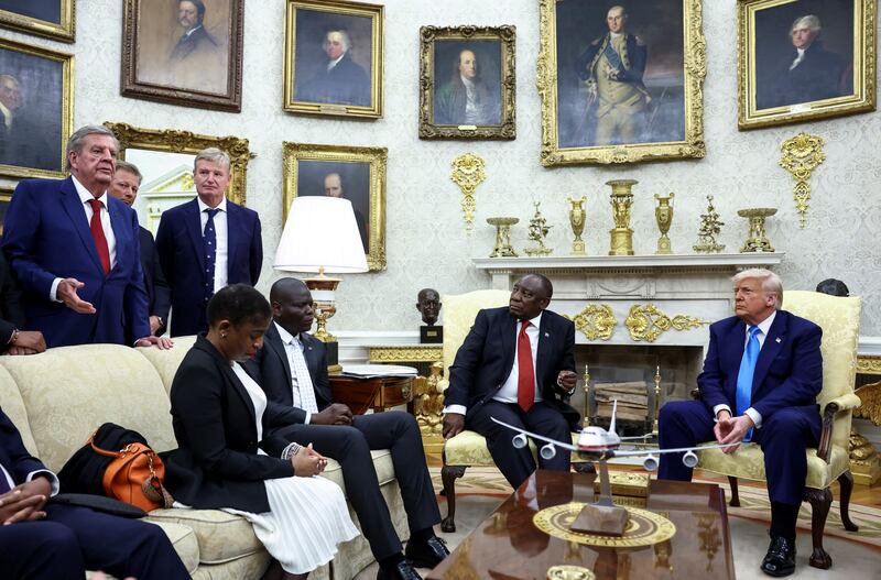 Businessman Johann Rupert speaks next to Golfers Retief Goosen and Ernie Els in the Oval Office, during a meeting between U.S. President Donald Trump and South African President Cyril Ramaphosa, at the White House in Washington, D.C.