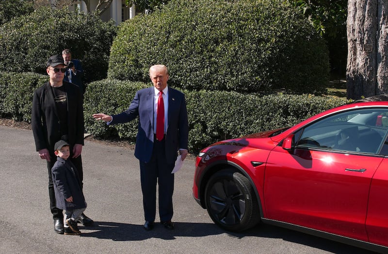 U.S. President Donald Trump, joined by White House Senior Advisor, Tesla and SpaceX CEO Elon Musk and his son X Æ A-Xii, delivers remarks next to a Tesla Model Y on the South Lawn of the White House on March 11, 2025 in Washington, DC.