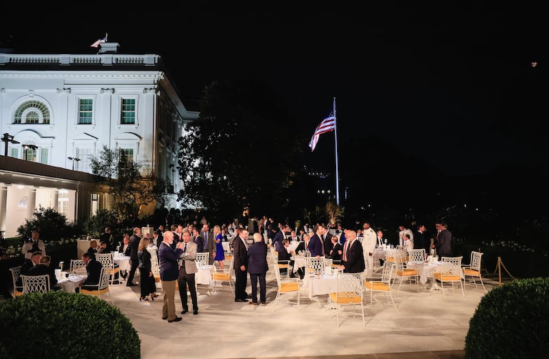 People attend a dinner for lawmakers, held by Donald Trump on the newly renovated Rose Garden patio, at the White House.
