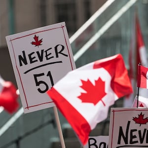 TORONTO, CANADA - MARCH 22 : People carrying Canadian flags and banners against '51st state' attend 'Elbows up, Canada!' rally, non-partisan, family-friendly gathering celebrating Canada's strength, unity, and resilience at Nathan Phillips Square in Toronto, Canada on March 22, 2025. (Photo by Mert Alper Dervis/Anadolu via Getty Images)