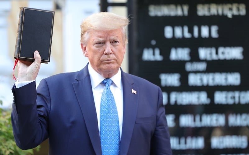 U.S. President Donald Trump holds up a Bible as he stands in front of St. John's Episcopal Church across from the White House after walking there for a photo opportunity during ongoing protests over racial inequality in the wake of the death of George Floyd while in Minneapolis police custody, at the White House in Washington, U.S., June 1, 2020. REUTERS/Tom Brenner