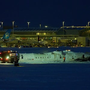 A Delta airlines plane sits on its roof after crashing upon landing at Toronto Pearson Airport in Toronto, Ontario, on February 17, 2025.