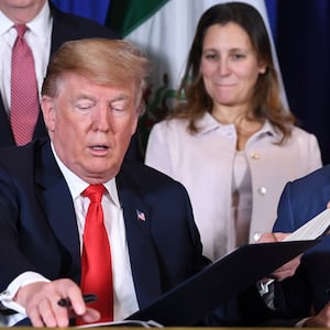 President-elect Donald Trump and Canadian Prime Minister Justin Trudeau sign a new free trade agreement as former Canadian Finance Minister Chrystia Freeland looks on in Buenos Aires, on November 30, 2018.