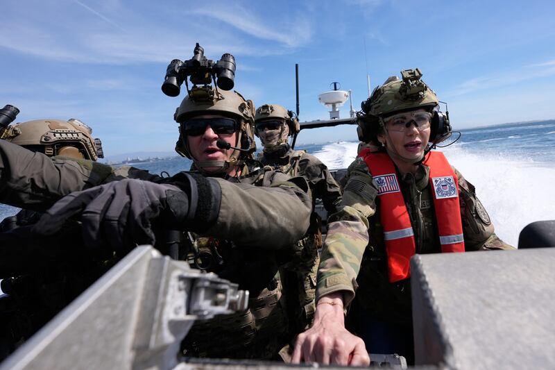 US Secretary of Homeland Security Kristi Noem (R) pilots a US Coast Guard Response Boat-Small (RBS) with the Maritime Security Response Team in San Diego, California, on March 16, 2025.